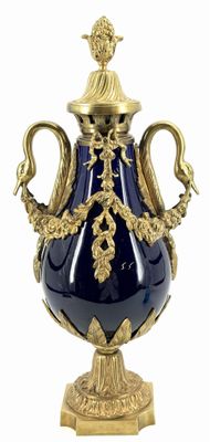 a large blue vase with a gold decoration on it