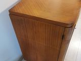 a wooden cabinet with a drawer on top of it