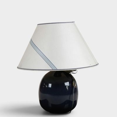 an image of a blue lamp with a white shade on it