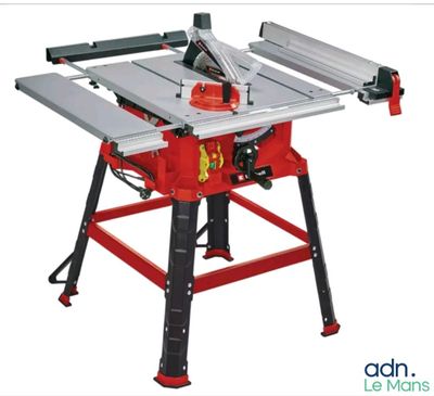 a red table sawing machine sitting on top of a table