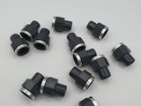 a bunch of black plastic pipe fittings on a white surface
