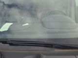 windshield of a car with a sticker on the windshield of it