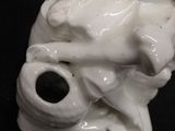 a close up of a figurine of a man with a pipe in his mouth