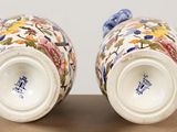 two vases that are sitting on a table
