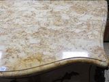 a table with a marble top on a tile floor