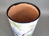 a vase that has a picture of a tree on it