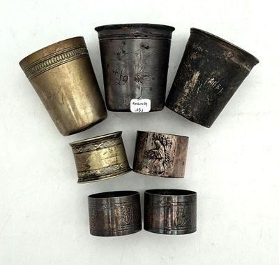a group of five silver and bronze napkin rings