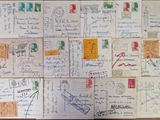 many postcards on the table with writing on them