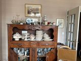 a china cabinet in the corner of the room