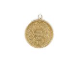 a close up of a gold coin on a white surface