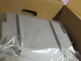 a box with a laptop in it that is wrapped in plastic