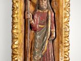 an old wooden statue of a man holding a staff in a gold frame