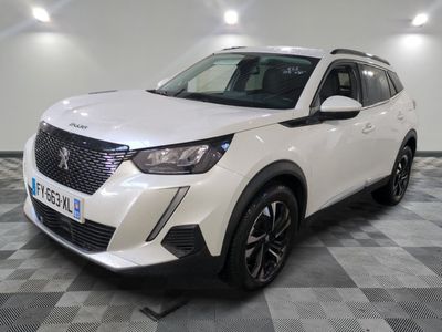un 4x4 blanc garé sur un sol en damier dans un garage
