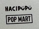 a black and white photo of a sign that says pop mart