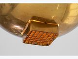 gold plated metal bowl with a grid design on the bottom