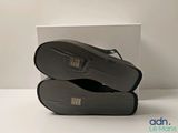 a pair of black shoes sitting on top of a white box