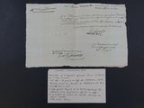 an old piece of paper with writing on it sitting on top of a table