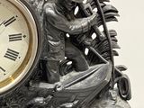 a clock that is sitting on a stand with a man on it