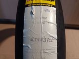 a close up of a bottle of tire oil on a table