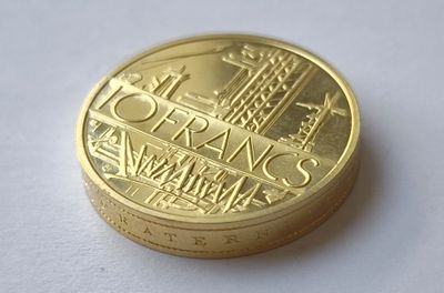 a gold coin with a picture of a city on it