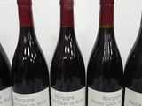 six bottles of red wine are lined up in a row