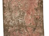 an old book with red paint on it sitting on a white surface