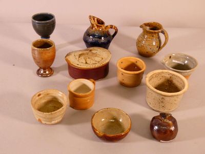 many different types of vases and bowls on the table