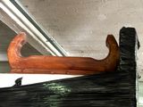 a wooden boat that is on display in a room