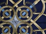 a blue and gold scarf with a design on it
