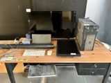 a desk with a laptop, monitor, keyboard and mouse on it