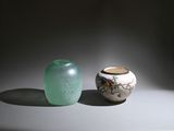 two vases sitting next to each other on a table