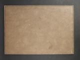 a close up of a piece of brown paper on a black surface
