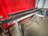 a red wall behind a bench in a building