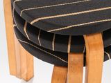 three wooden stools with black and white stripes on them