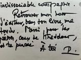 handwriting on a piece of paper with a note attached to it