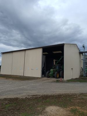 an image of a large building with a tractor in front of it