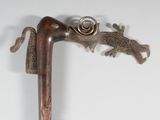 a metal object that looks like a snake on a stick