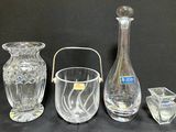 three glass vases and a glass candle holder on a black background