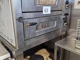 an oven that is sitting in the middle of a kitchen