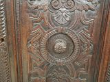 a close up of a wooden panel with carvings on it