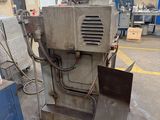 a picture of a machine in a factory with a blue table