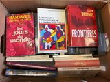 books in a cardboard box are stacked on top of each other