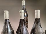 several bottles of wine are lined up on a table