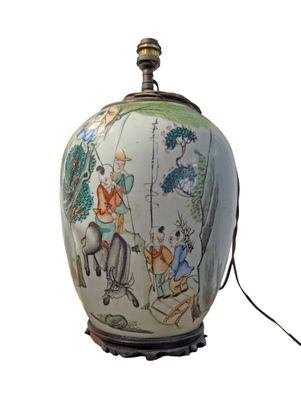 a lamp that has a picture of a man riding a horse on it