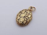 a close up of a gold locke with a flower on it