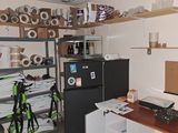 a small room with a refrigerator and a bike in it