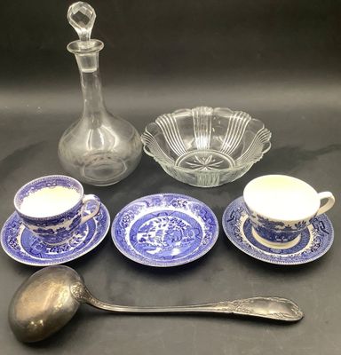 a lot of blue and white dishes and spoons on the table