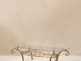 table basse en fer forgé avec plateau en verre et motifs en volutes