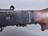 an old rifle with a wooden handle on a white background