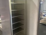 an image of a refrigerator with its door open in a warehouse